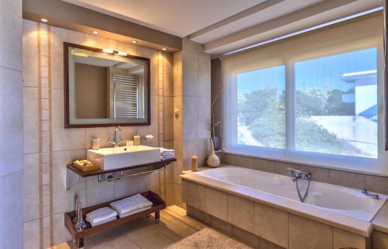 A full bathroom with tub villa for sale in Crete Greece