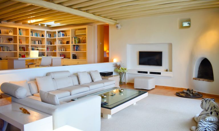 Living room with traditional fireplace, property for sale in Mykonos, Greece